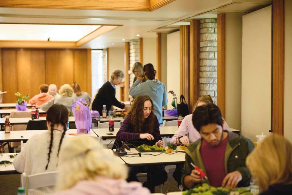 Students work with orchids during Powell Gardens' Orchid Symposium